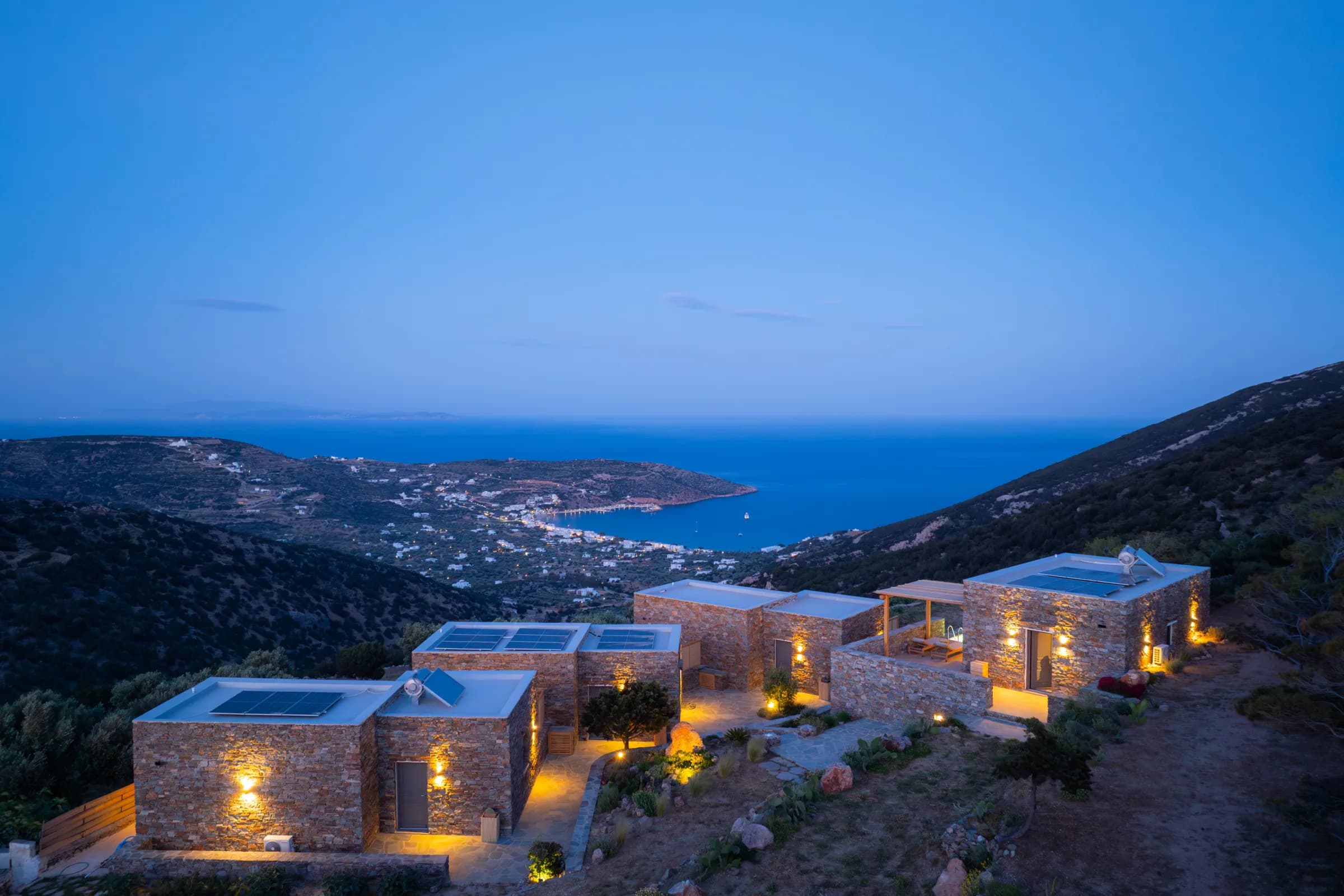 Refoulia Eco Suites β Suites with solar panels at dusk overlooking Sifnos bay